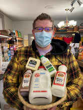 Load image into Gallery viewer, Jon holding an african basket filled with milk like glass bottle milk and goat milk