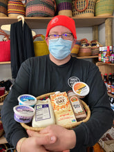 Load image into Gallery viewer, Jon holding an african basket with plant based cheese and milk 
