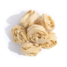 Load image into Gallery viewer, pile of pasta strips wrapped into balls
