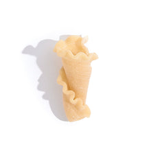Load image into Gallery viewer, single piece of beige pasta in a seashell trumpet shape