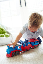 Load image into Gallery viewer, a small boy playing with a train set