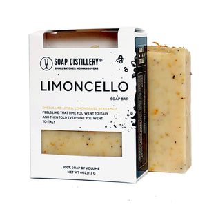 a yellow bar of soap with orange black and brown speckles of soap that smell like litsea, lemongrass, and bergamot