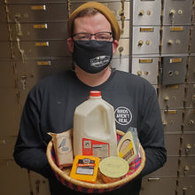 Load image into Gallery viewer, Jon Henry holding an african basket of dairy items like cheese and milk
