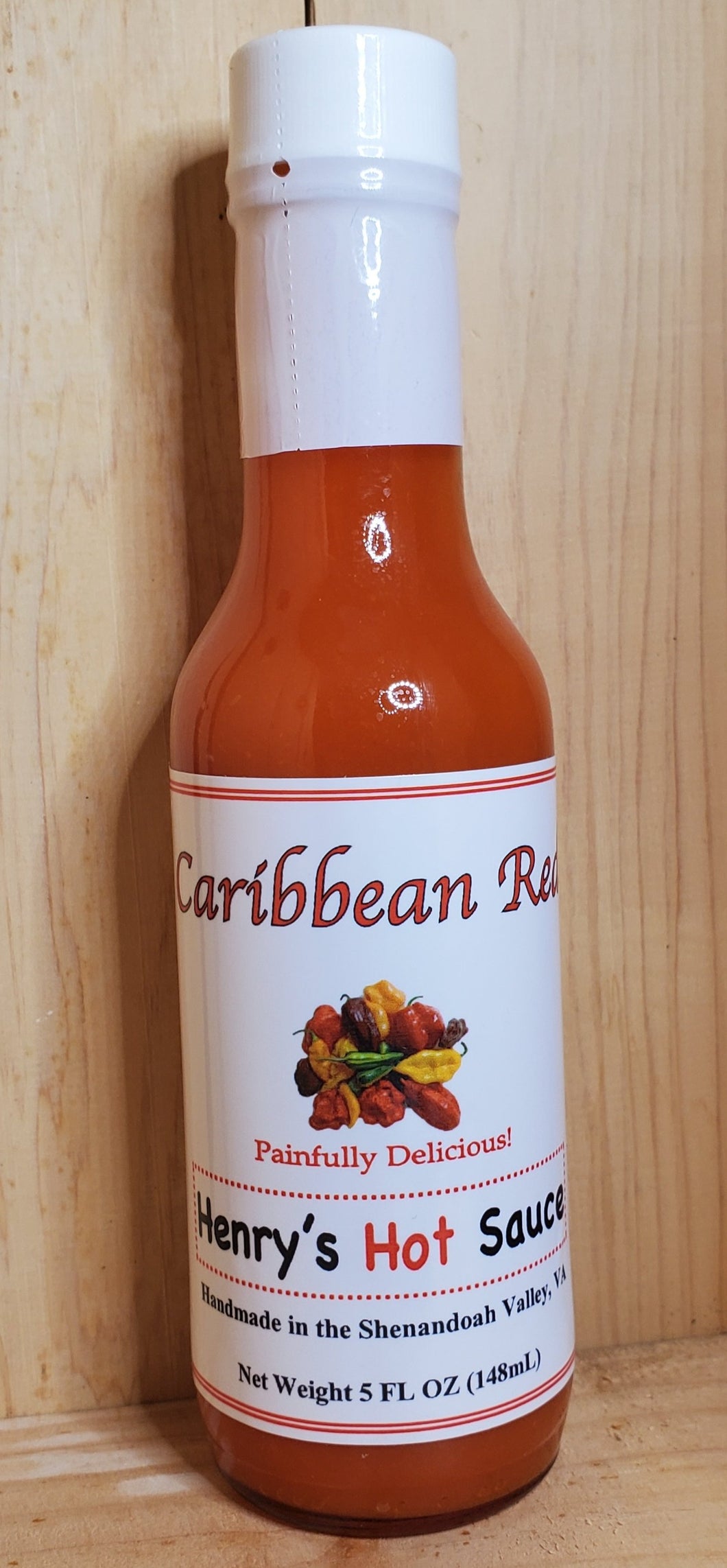 glass bottle of caribbean red hot sauce