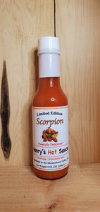 glass bottle of red scorpion hot sauce