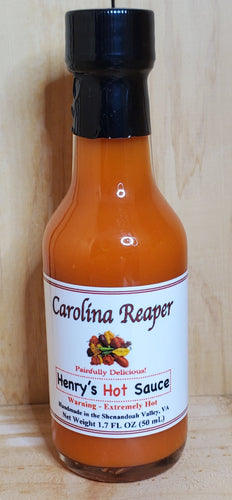small glass bottle of red carolina reaper hot sauce