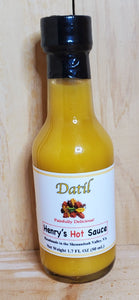 small glass bottle of yellow datil hot sauce