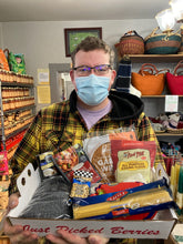 Load image into Gallery viewer, jon holding a box of pantry items like gluten free flour pasta beans peanuts
