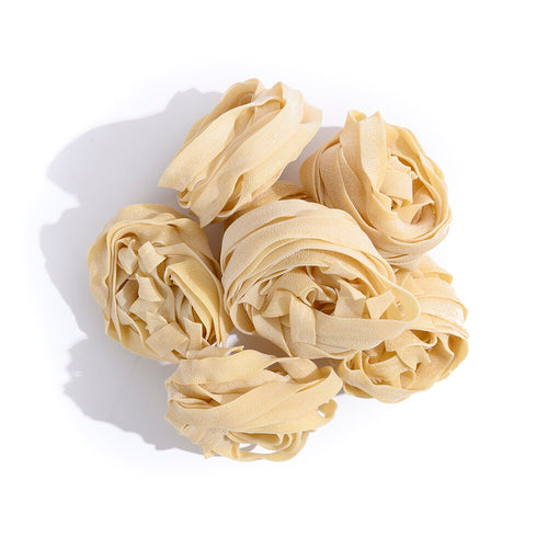 pile of pasta strips wrapped into balls